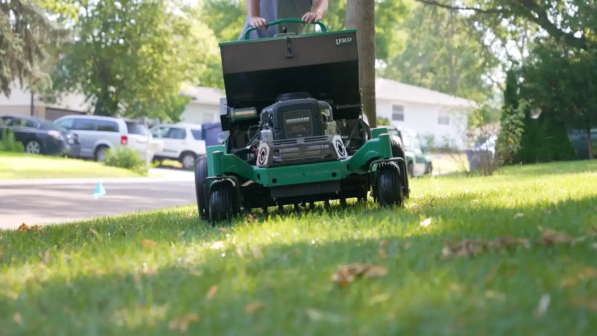 A healthy green Nebraska lawn being core aerated in early fall